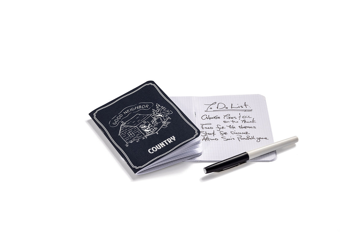Second front image of the Country navy pocket-sized notebook. Inside there is grid paper and a to do list written by the founder of Country cannabis